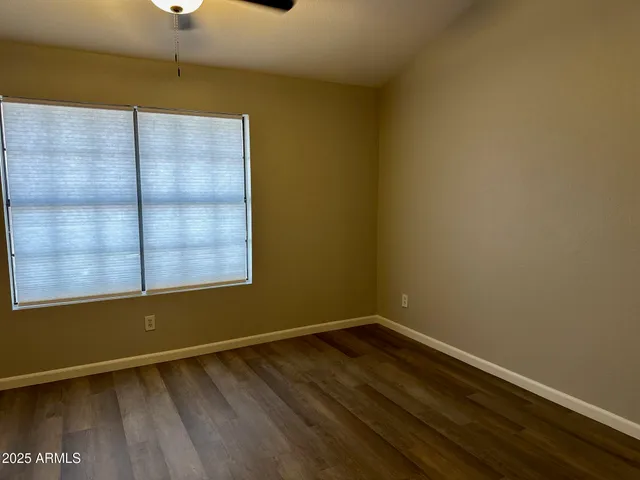 a view of a room with wooden floor and windows