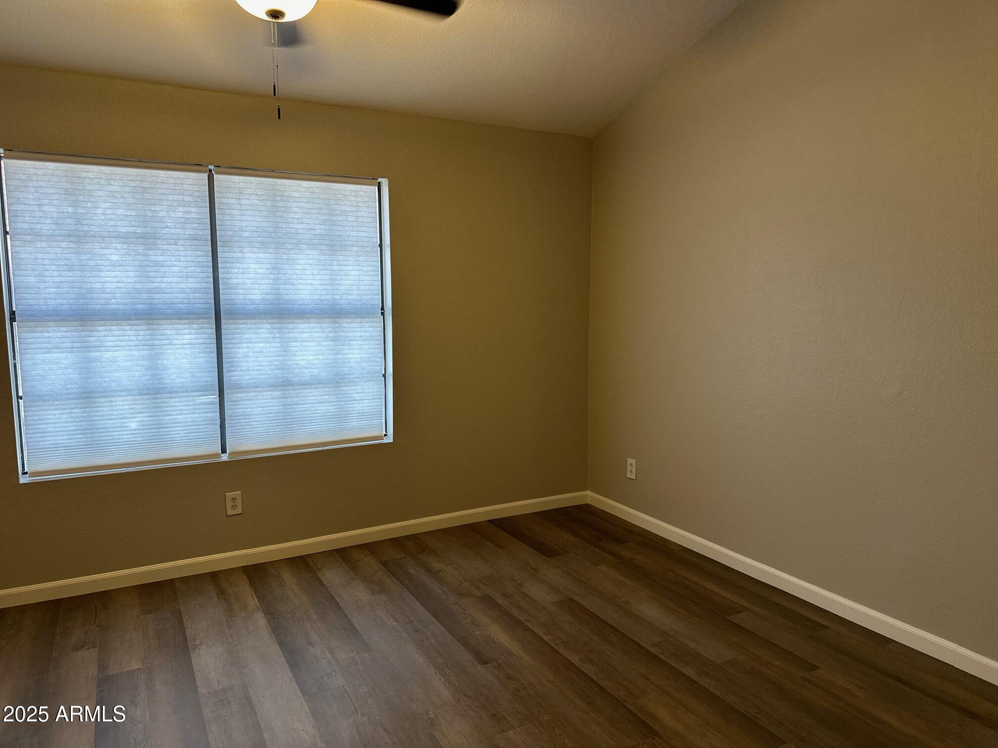 3491 North Arizona Avenue, Unit 20 Chandler, AZ 85225 - Photo 8 of 13 a view of a room with wooden floor and windows