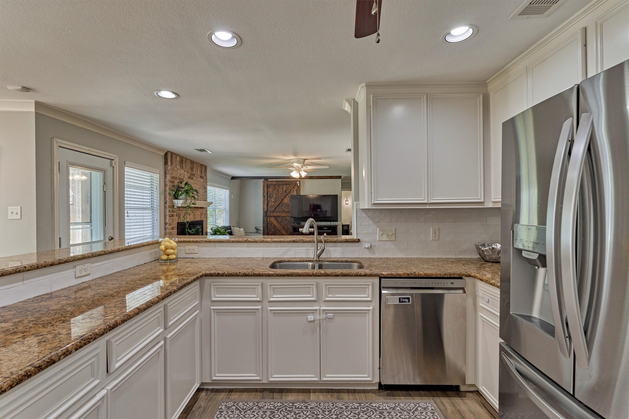 6515 Glenhill Drive Spring, TX 77389 - Photo 11 of 39 a kitchen with stainless steel appliances a sink stove and refrigerator