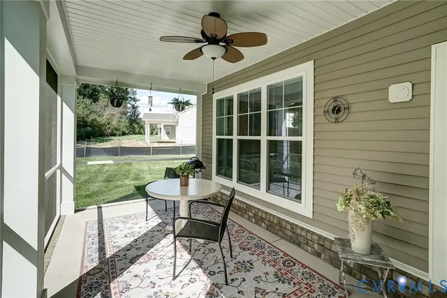 a view of a porch with furniture and a yard