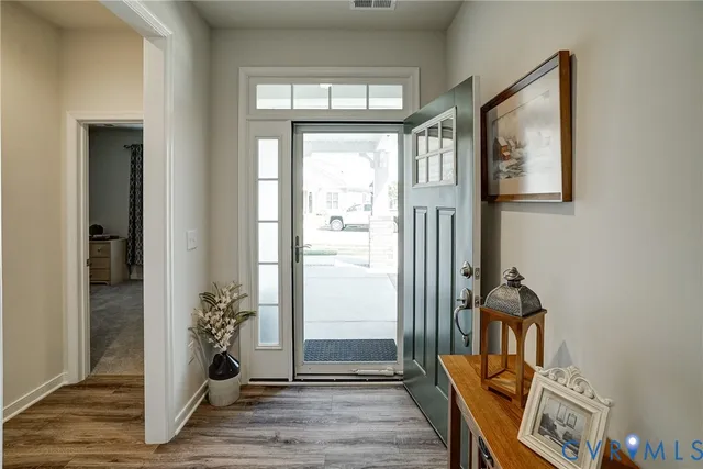 a view of an entryway with wooden floor