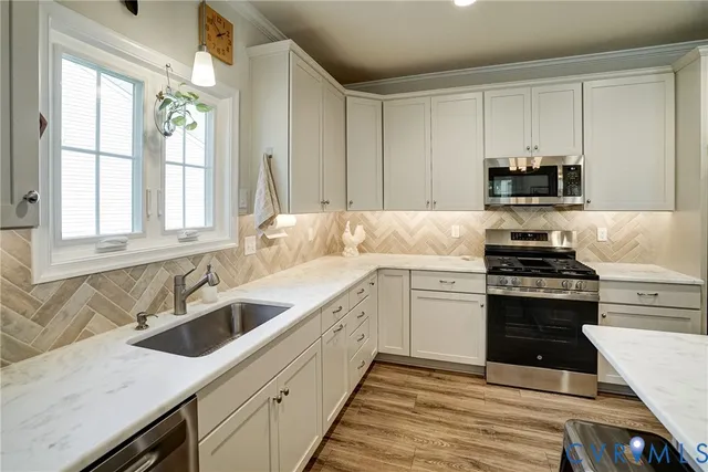 a kitchen with a sink stove top oven and cabinets