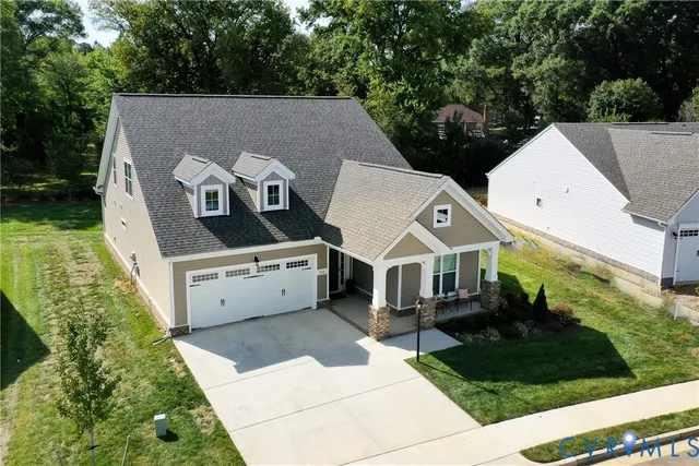 an aerial view of a house with a yard