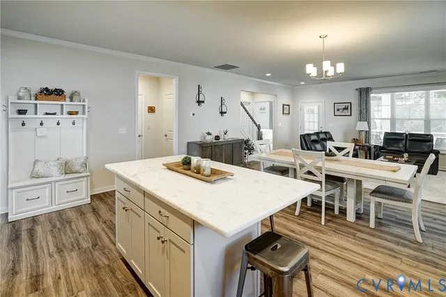 a large kitchen with a table and chairs