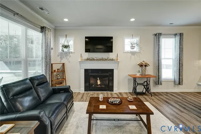 a living room with furniture a flat screen tv and a fireplace