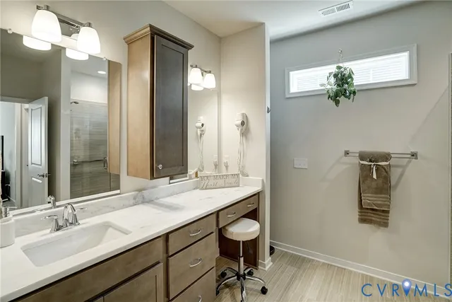a bathroom with a granite countertop sink a toilet and a mirror