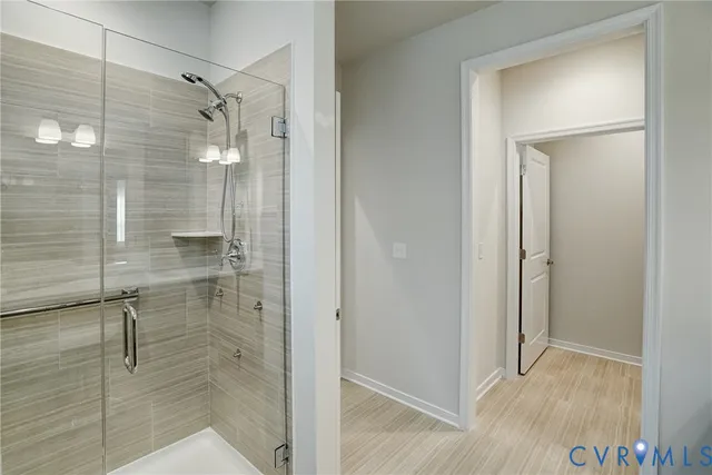 a bathroom with a glass shower door