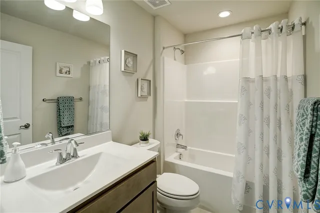 a bathroom with a sink toilet tub and shower