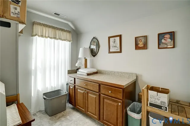 a room with a table chairs and a window