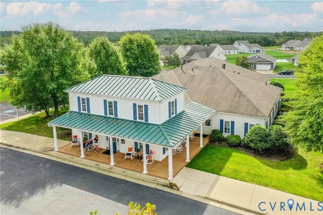 an aerial view of a house with a yard