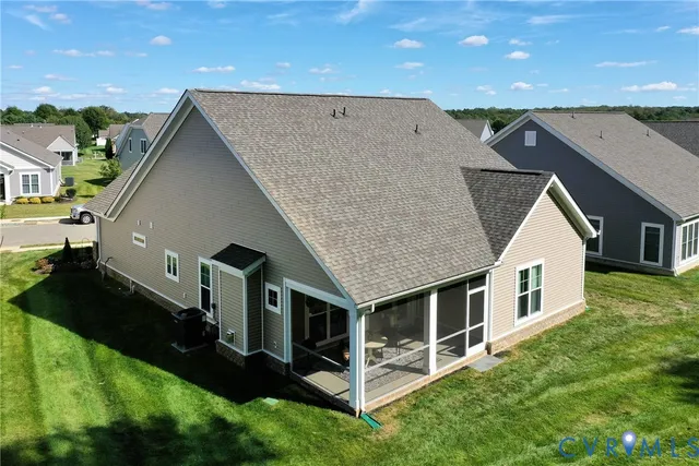 a aerial view of a house next to a big yard and large trees