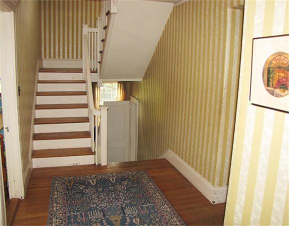 52 Livermore Road Wellesley, MA 02481 - Photo 3 of 9 a view of a hallway with wooden floor and staircase