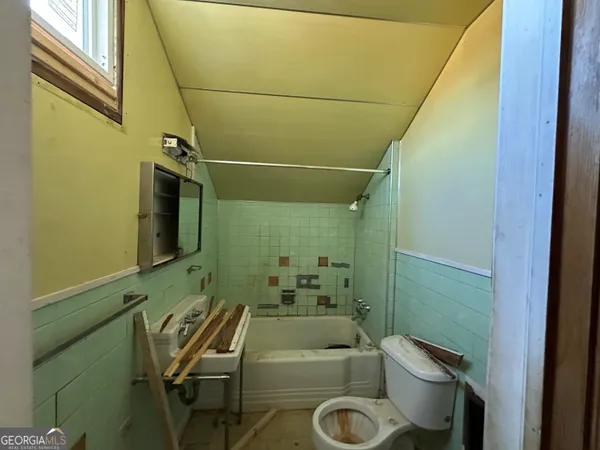 a bathroom with a sink and toilet