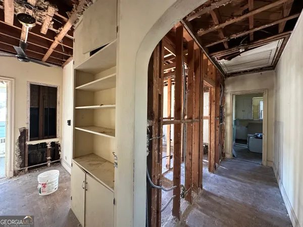 a view of a room with wooden floor and windows