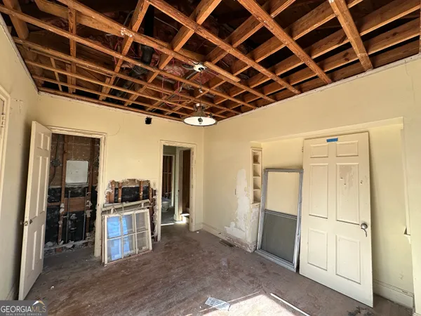 a view of kitchen with refrigerator and wooden floor