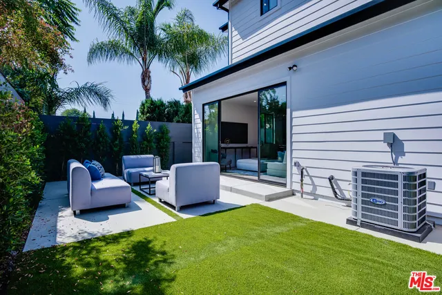 a view of a patio with couches chairs and a fire pit