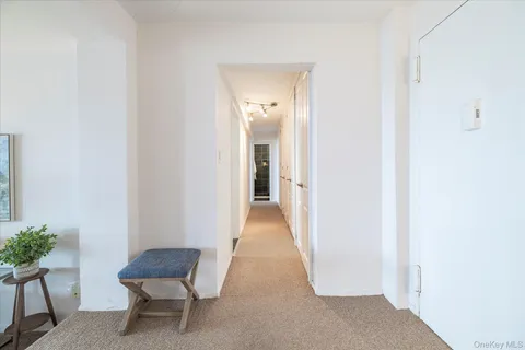 a view of a hallway with wooden floor and a workspace