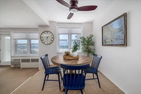 a view of a dining room with furniture and a chandelier