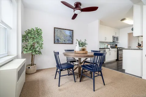 a dining room with furniture and window