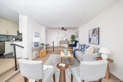a living room with furniture a dining table and chairs