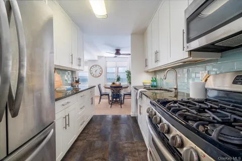 a kitchen with stove top oven sink and cabinets