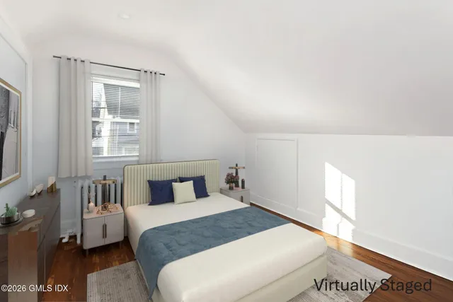 a bedroom with a large bed and a window