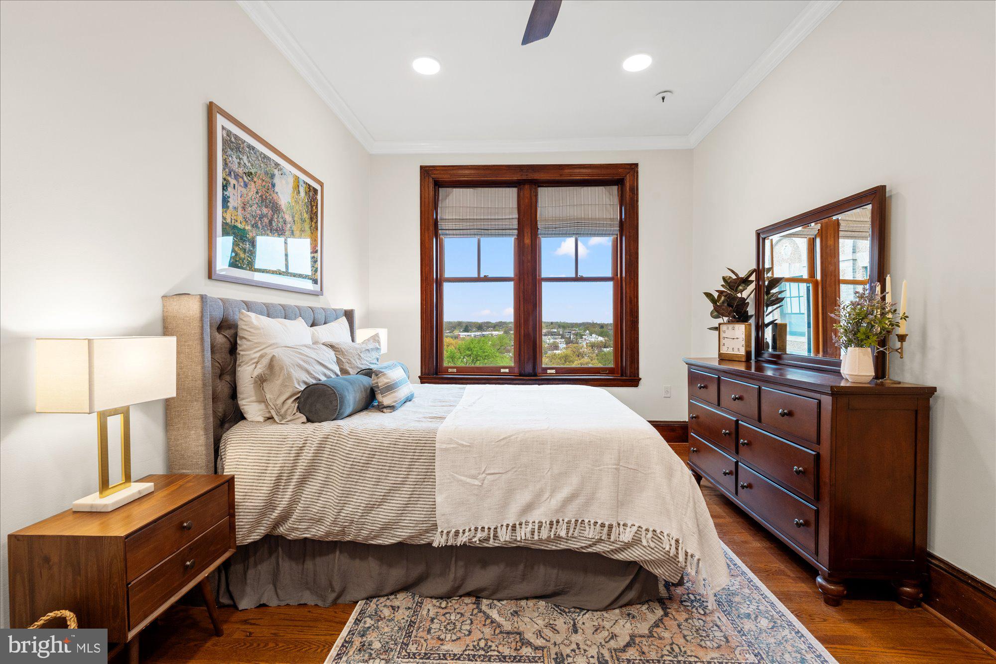 2853 Ontario Road Northwest, Unit 609 Washington, DC 20009 - Photo 11 of 14 a bedroom with a bed next to a window with dresser