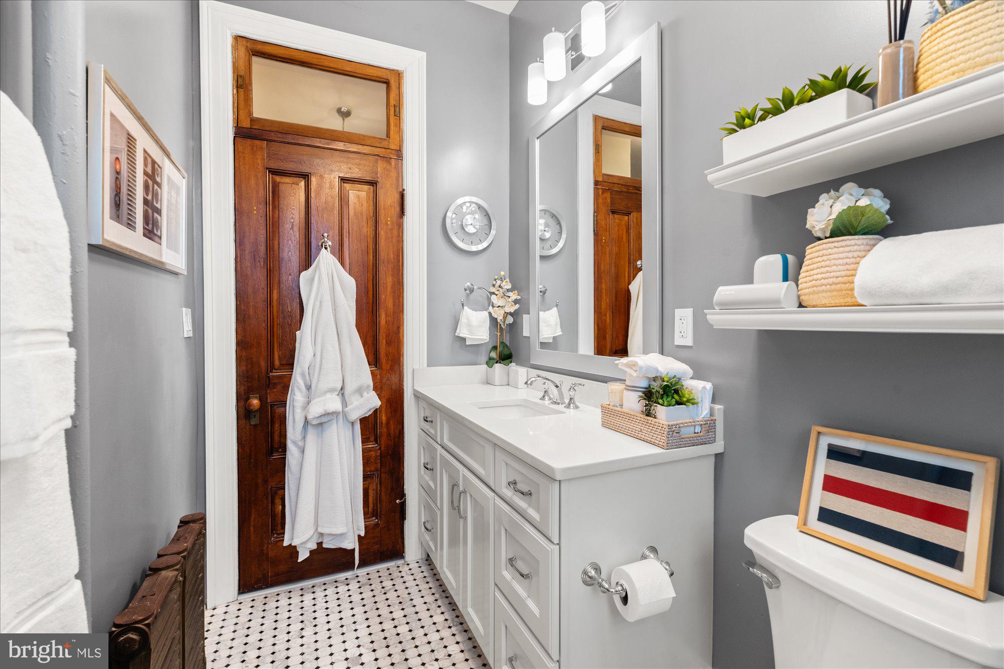 2853 Ontario Road Northwest, Unit 609 Washington, DC 20009 - Photo 13 of 14 a bathroom with a sink a vanity and a mirror