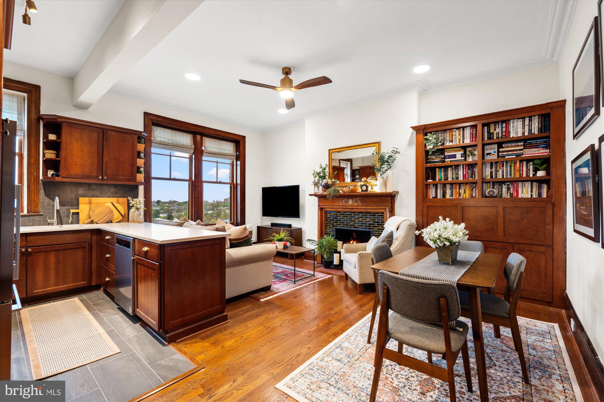 2853 Ontario Road Northwest, Unit 609 Washington, DC 20009 - Photo 2 of 14 a living room with fireplace furniture and a table