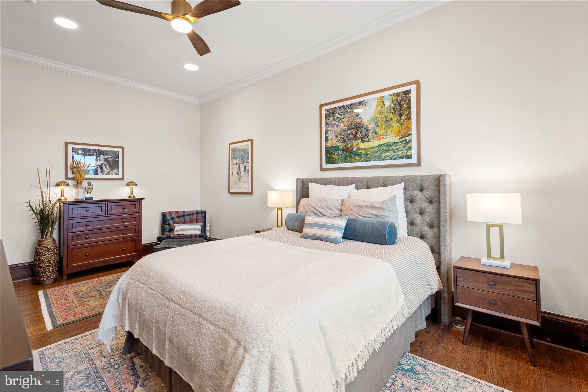 2853 Ontario Road Northwest, Unit 609 Washington, DC 20009 - Photo 8 of 14 a bedroom with a bed and a chandelier
