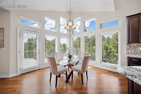 a view of a dining room with furniture large windows and wooden floor