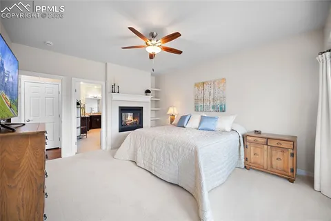 a spacious bedroom with a bed and a fireplace