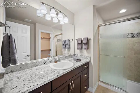 a bathroom with a granite countertop sink mirror and double