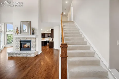 a view of a livingroom with wooden floor and a fireplace