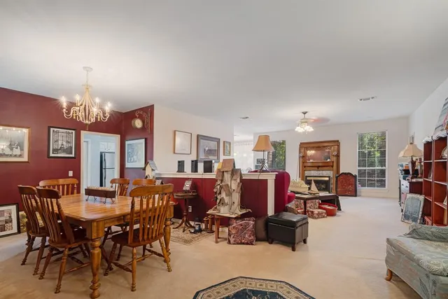 a view of a dining room with furniture and chandelier
