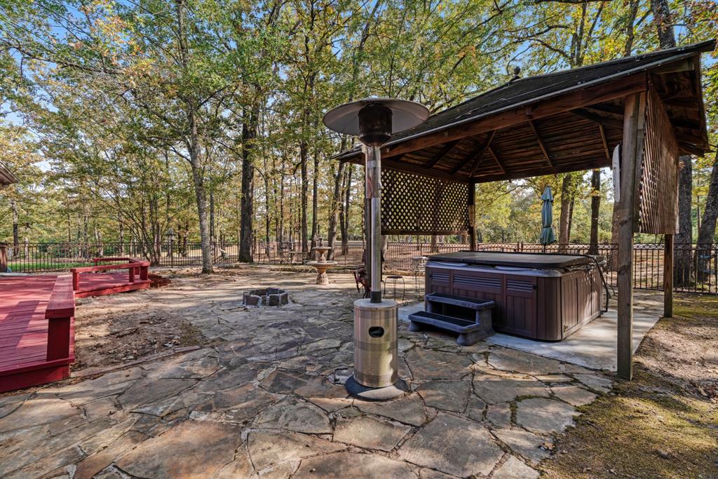 700 Hidden Lake Drive Powderly, TX 75473 - Photo 19 of 32 a backyard of a house with barbeque oven table and chairs