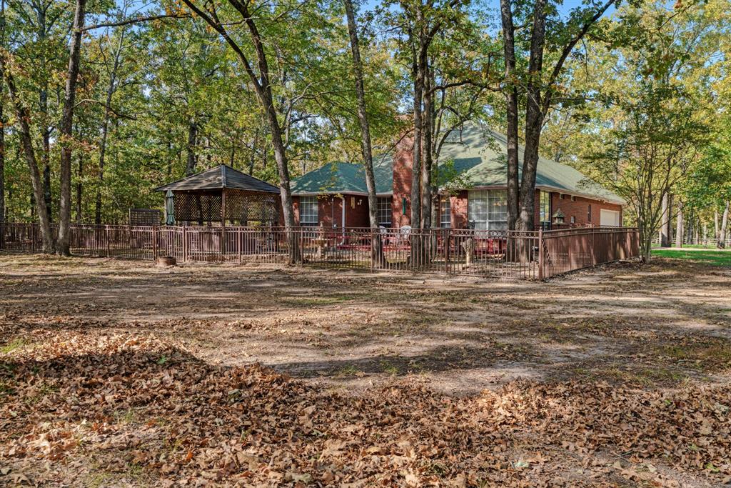 700 Hidden Lake Drive Powderly, TX 75473 - Photo 22 of 32 a front view of a house with a yard