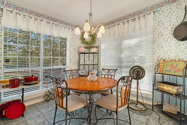 a backyard of a house with table and chairs