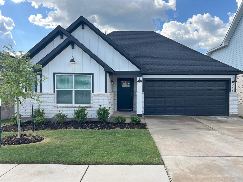 248 Lone Cedar Road Marble Falls, TX 78654 - Photo 1 of 32 a front view of a house with a garden and yard