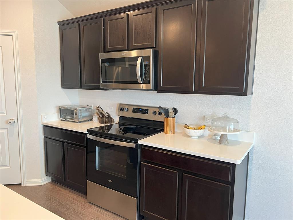 248 Lone Cedar Road Marble Falls, TX 78654 - Photo 11 of 32 a kitchen with a sink stove and microwave