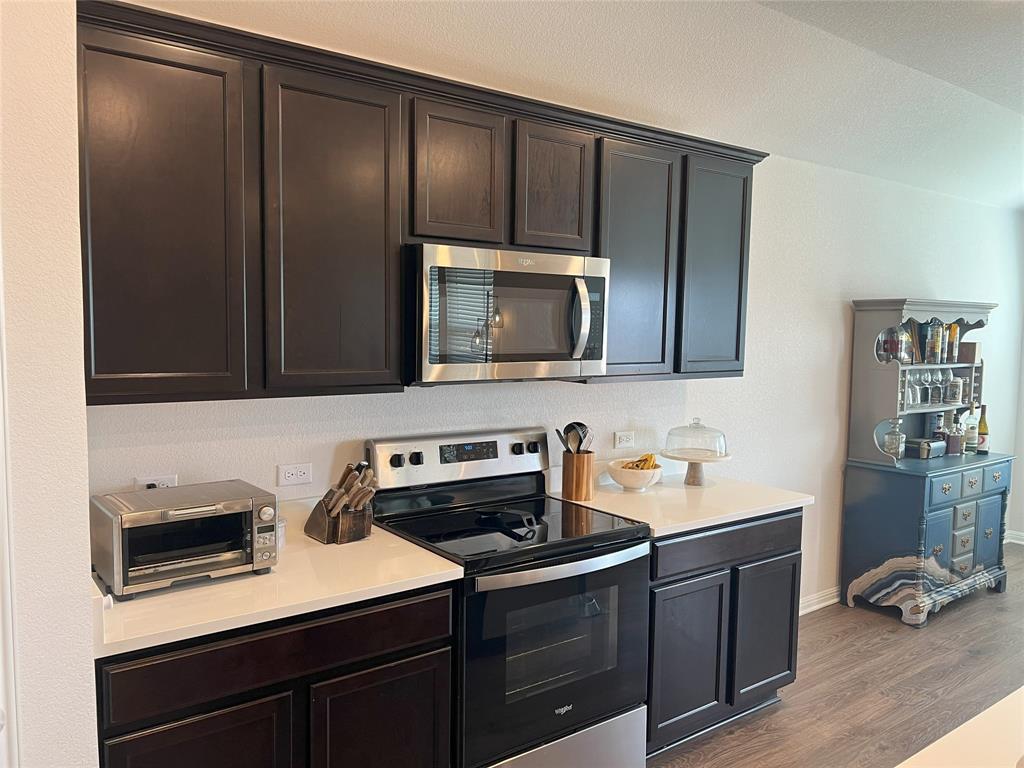 248 Lone Cedar Road Marble Falls, TX 78654 - Photo 12 of 32 a kitchen with stainless steel appliances a stove microwave and sink