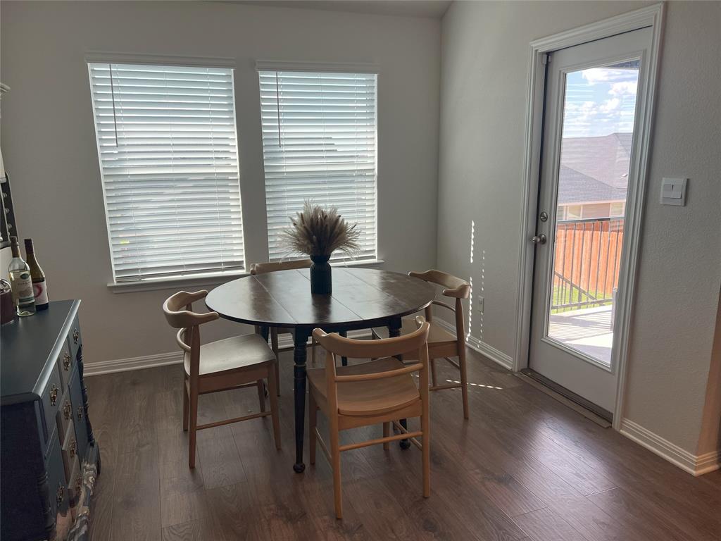 248 Lone Cedar Road Marble Falls, TX 78654 - Photo 16 of 32 a view of a dining room with furniture and wooden floor