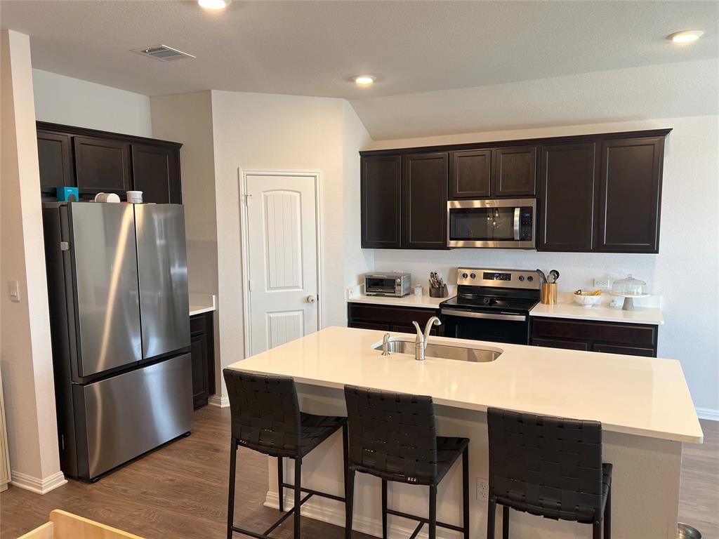 248 Lone Cedar Road Marble Falls, TX 78654 - Photo 9 of 32 a kitchen with stainless steel appliances a refrigerator stove microwave and cabinets