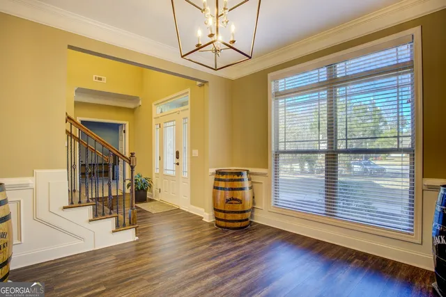 a view of a livingroom with wooden floor and furniture