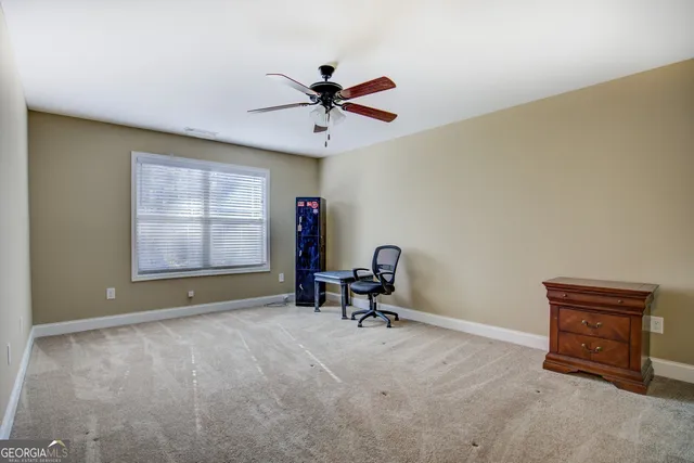 an empty room with a fireplace and windows