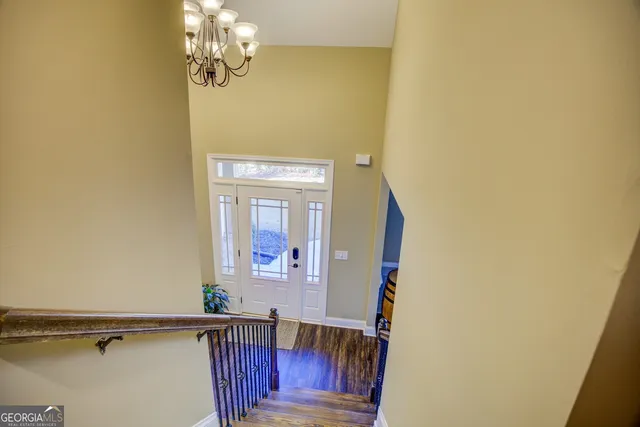 a swimming pool with a yard and wooden fence