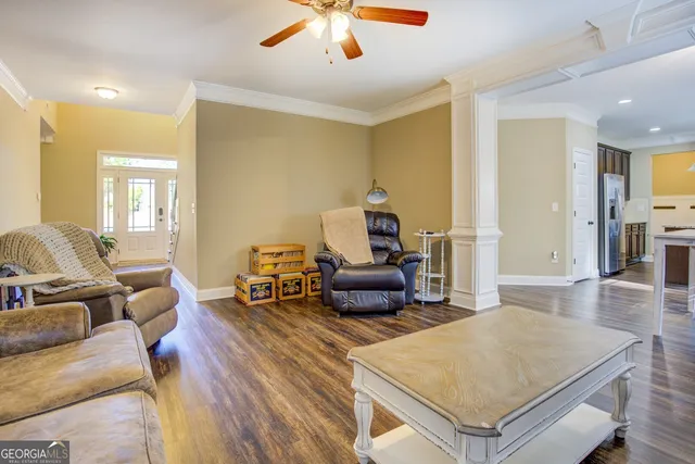 a living room with furniture and a wooden floor