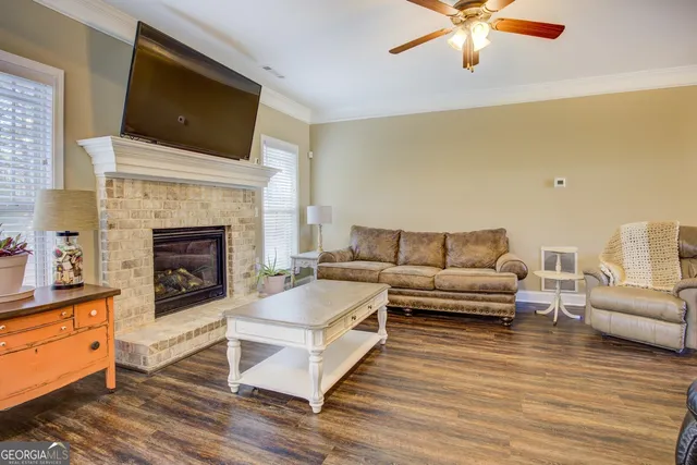 a living room with furniture a fireplace and a flat screen tv