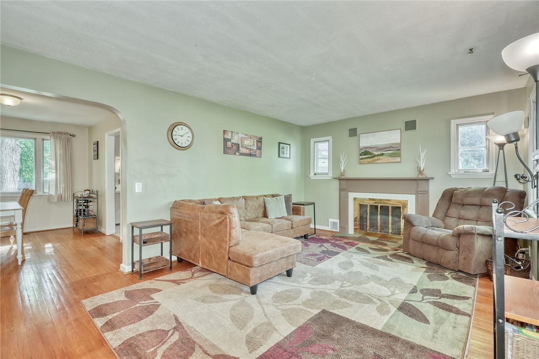 606 Bay Road Webster, NY 14580 - Photo 7 of 49 Family room with hardwood floors, woodburning fire