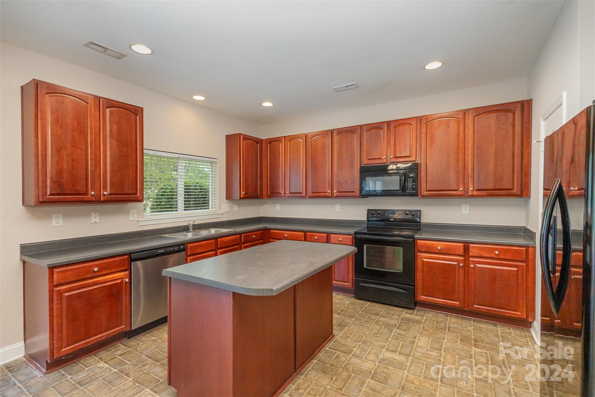 503 Waterlemon Way Monroe, NC 28110 - Photo 7 of 22 a kitchen with stainless steel appliances granite countertop wooden cabinets a sink and a stove